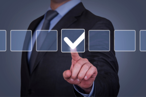keep your business in good standing - man pointing to a checkmark