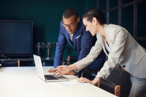 picture of two business people looking at a computer