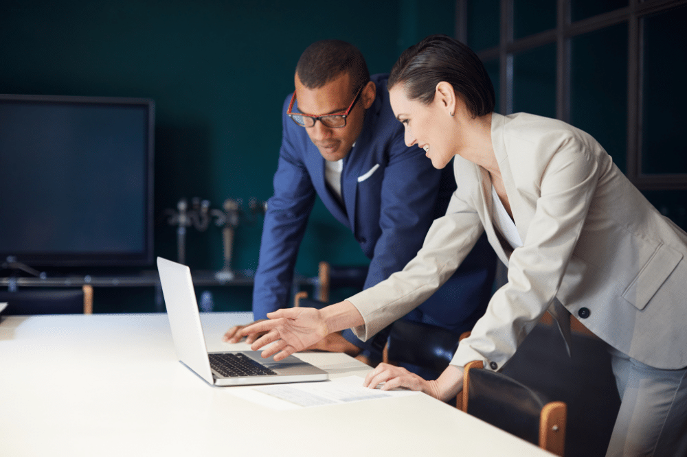 picture of two business people looking at a computer